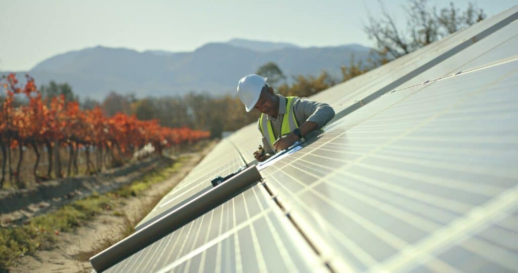 technical staff inspecting solar panel